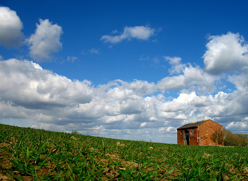 An old, abandoned red brick barn on top of Meon Hill